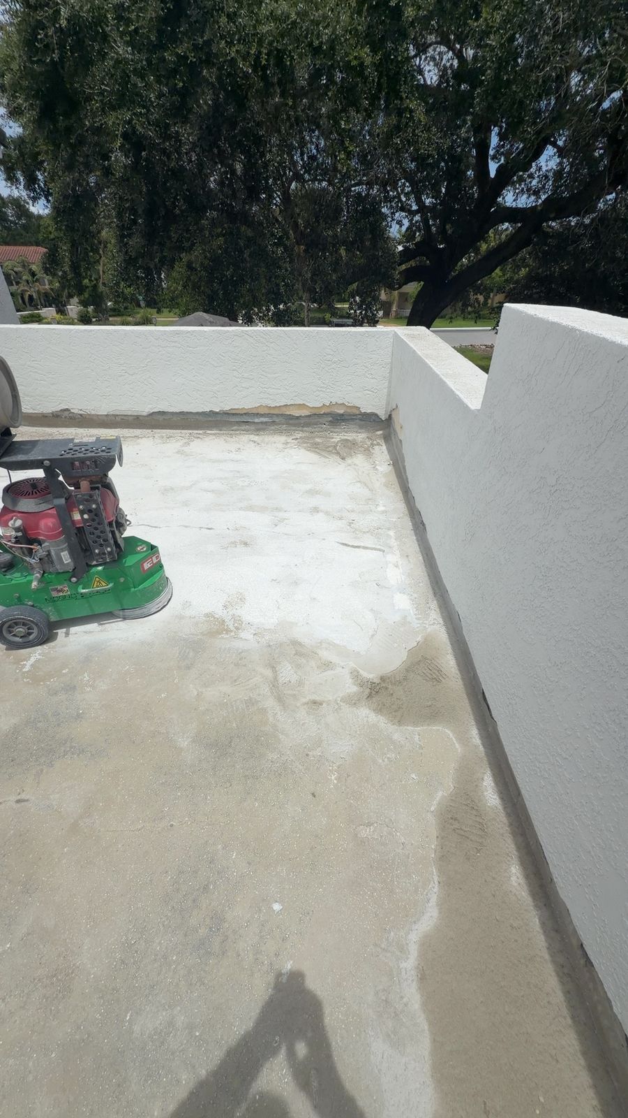 Hunter Construction grinding a rooftop deck to bare concrete to prep for waterproofing in Palm Beach County