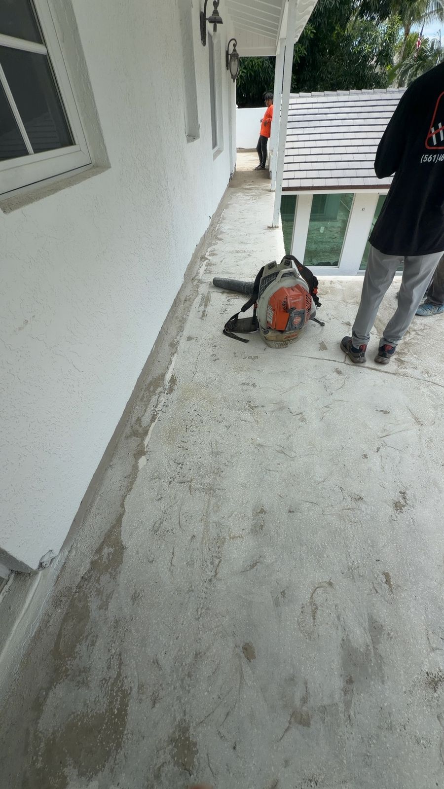 Hunter Construction crew prepping a second-floor walkway for fluid-applied waterproofing